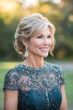 a woman in a blue dress smiling at the camera