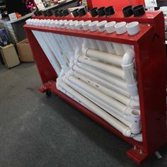 a red rack with many white pipes on it