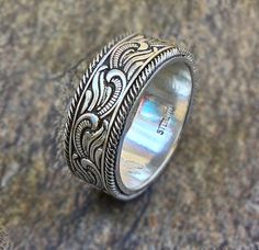 a silver ring sitting on top of a rock