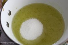 a white bowl filled with green liquid on top of a table