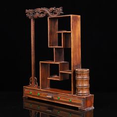 an old wooden desk with shelves and drawers on it's sides, in front of a black background