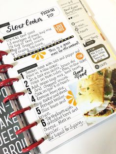 a recipe book is open on top of a white table with red spiral binders