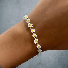 Daisy cabin flower bracelet with silver lobster clasp Adjustable Bracelet With Flower Decoration, Flower Shaped Bracelets For Beach, Adjustable Flower Bracelet With Flower Decoration, Trendy Summer Bracelet With Flower Charm, Spring Bracelets With Adjustable Flower Decoration, Trendy Summer Bracelets With Flower Charm, Adjustable Bracelet With Flower Decoration For Spring, Adjustable Flower Bracelets For Spring, Adjustable Spring Bracelet With Flower Decoration