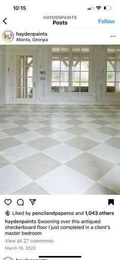 an empty room with two windows and a checkered floor in front of the door