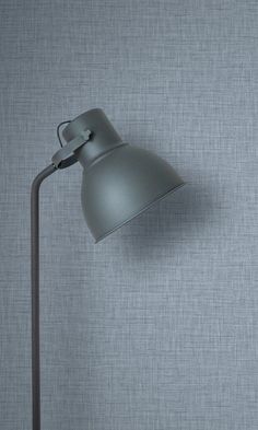 a gray lamp on a grey wall