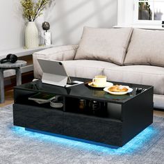 a coffee table with a laptop on it