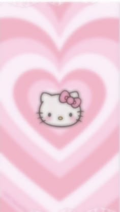 a pink heart with a hello kitty face on it