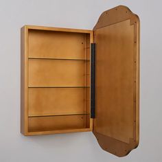 an open wooden box with shelves on the wall