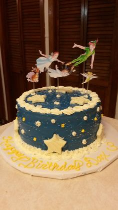 a blue and yellow birthday cake with tinker stars