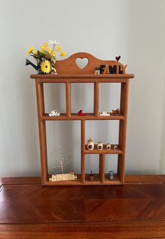 a wooden shelf with flowers on top of it