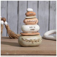 a stack of rocks with the words have courage and be kind written on them