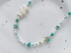 A beautiful blue color palette to express yourself in. This beaded necklace features natural shell, turquoise beads and Japanese seed beads for a distinctive finish. It is a great stand alone piece and I like to layer it with simple silver chains too! 🌹 Measurement: ➺ Overall length: 14.5 inch + 2.3 inch extension chain (37cm + 6cm) ✉️ Shipping: Canada: Untracked oversized lettermail handled by Canada Post: arrives in 5-15 business days. US: Tracked parcel handled by USPS: arrives in 5-15 busin Ocean-inspired Turquoise Beaded Necklaces As Gift, Ocean-inspired Turquoise Beaded Necklaces For Gifts, Turquoise Strand Beaded Necklace As Gift, Turquoise Strand Beaded Necklace For Gift, Turquoise Gemstone Beads For Beach, Turquoise Ocean-inspired Necklaces For Jewelry Making, Ocean-inspired Turquoise Beaded Necklace, Turquoise Ocean-inspired Beaded Necklace, Turquoise Beaded Necklaces With Round Beads, Ocean-inspired