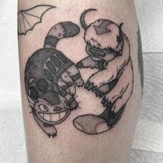 a tattoo on the leg of a man with an image of two otters holding hands