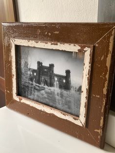 an old photo frame sitting on top of a table