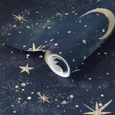 a blue wallpaper with gold stars and a crescent on the left side, against a dark background