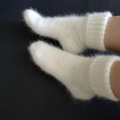 Very warm angora wool socks will keep your feet warm. The socks are thick. Also suitable for home  I can do in other colors. contact me beforehand Hand knit socks Very soft and warm socks. Socks will keep your feet warm in cold weather. Composition: angora (rabbit) yarn Size: choice a select Color: white naturale Ready to ship SIZE:  EU 36-37 (22-23 santimeters) - US 5-6 (8.7-9.1 inch) EU 38-39 (24-25 santimeters) - US 7-8 (9.5-9.8 inch) EU 40-41 (26-27 santimeters) - US 9-9.5 (10.2-10.6 inch) E Thick Knitted White Socks, Comfortable Thick Knitted Socks, Thick Warm White Socks, Soft Round Toe Socks For Gifts, Thick Knitted Socks, Lovebrush Chronicles, Emma Ross, Fluffy Bedding, Handmade Socks