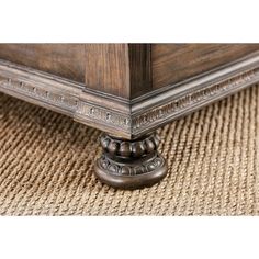 a close up view of the base of a bed frame and foot board on a carpeted floor