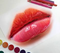 a drawing of a red lip with some colored pencils next to it