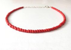 This red bead necklace is 100% handmade with beautiful glass seed beads. It can be made either 14, 16, 18, or 20 inches long, and each necklace comes with additional extender chain, making it easily adjustable. This necklace goes great with so many outfits- dress it up for a fancier event, or wear it with jeans and a t-shirt. It also makes a simple yet amazing gift for a family member, friend or loved one! Handmade Adjustable Red Choker, Red Bead Choker For Festivals, Red Beaded Choker Necklace As Gift, Red Beaded Choker Necklace For Gift, Red Beaded Chain Bracelets For Festival, Red Beaded Choker Necklaces For Festival, Red Beaded Chain Bracelet For Festival, Red Beaded Choker Necklace For Festivals, Adjustable Handmade Red Choker