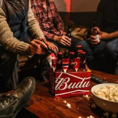 people sitting around eating popcorn and drinking beer