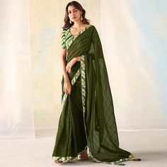 Mehendi Green colored saree is made from georgette fabric which is highlighted with beautiful weaving with fancy lace border & tassels as shown. comes along unstitched digital printed banglori silk blouse piece which you can customise as per your design/style. Occasion - You can buy this saree for party and functions. Note:- The actual product may differ slightly in color and design from the one illustrated in the images when compared with computer or mobile screen. Measurements: Saree : Georget