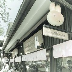 a store front with bunnies hanging from it's ceiling and bunny ears on the windows