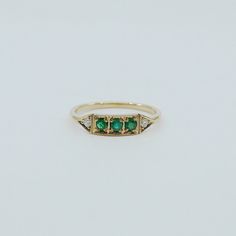 This is Ms. Goodbar, a little like a Mr. Goodbar candy bar in that it's delicious! Amazing green colored goodness in the middle sandwiched between two diamonds. The details in this ring are not to be missed, truly unique and special. Details: 14k (available in rose, white or yellow) Outer diamonds measure about 1.6mm Emeralds measuring about 2mm each Free Shipping on Domestic Orders Materials: emerald, diamond, 14k gold Need your ring bigger than whats offered? An additional fee will be applied Emerald Pinky Ring, Jewelery Ring, Mr Goodbar, Antique Emerald Ring, Rose Gold Cuff Bracelet, Emerald Ring Vintage, Dainty Band, Future Engagement Rings, Initial Earrings