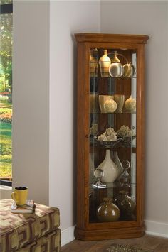 a tall wooden display case with glass doors