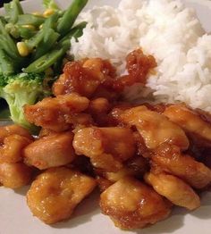 chicken and rice on a plate with broccoli, green beans and white rice