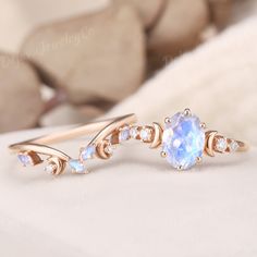 a ring with an oval blue stone surrounded by small white stones and gold plating