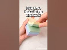 a hand holding a piece of paper with the words sticky notes hacks that you didn't know