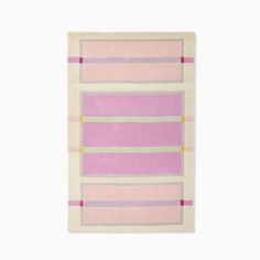 a pink and yellow striped rug on a white wall