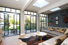 a living room filled with furniture and lots of windows