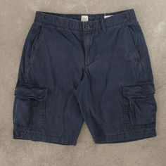 Women's Vintage Gap Cargo Shorts  + Closure: Zip  + Colour: Navy Blue  + Size Label States: W28  + Actual measurements (inches): W28  + Measurements (Inches): Hem = 9.5, Rise = 9.5  Please note that all vintage items have been previously worn, and may show some signs of previous wear. However, any significant damage will be photographed and/or stated in the items listing. Please note that damage to the inside may not always be photographed or listed. Denim Blue Cotton Shorts With Pockets, Short Denim Blue Pants With Pockets, Denim Blue Cotton Shorts With Side Pockets, Casual Denim Blue Shorts With Patch Pockets, Mid-rise Cotton Cargo Shorts With Pockets, Casual Mid-rise Cotton Cargo Shorts, Mid-rise Cotton Shorts With Pockets, Blue Short Bottoms With Patch Pockets, Mid-rise Cotton Cargo Shorts With Side Pockets