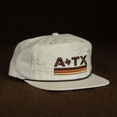 We're taking you back to simpler times with this vintage-inspired Austin, Texas grandpa rope hat. This instant classic features a medium crown height, lightweight nylon, breathable fabric, a snapback closure, and a pliable bill for a customized fit. Want to spend a quiet day on the water? Our ATX snapback hat is also water resistant! Hook yourself the hat that will keep you in style. Fun Hats, Dope Hats, Baseball Snapback, Flat Bill Hats, Simpler Times, River Road, Quality Hats, Golf Hats, University Of Texas