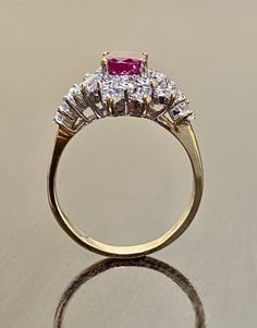 DeKara Designs Clearance Metal- 14K Yellow Gold, .583. Stones- 1 Oval Ruby 1.58 Carats, 14 Round Diamonds G- H Color VS2-SI1 Clarity, 10 Baguettes Diamonds G-H Color VS2-SI1 Clarity 1.02 Carats total weight. Size- 7 3/4. FREE SIZING Handmade 14K Yellow Gold Oval Ruby Baguette and Round Diamond Engagement Ring. This ring is inspired by the Art Deco era with an enticing Oval Ruby that is professionally set in between four prongs. All the diamonds surrounding the ruby are prong set with six round d Classic Marquise Ruby Ring With Brilliant Cut, Classic Marquise Ruby Ring With Vvs Clarity, Timeless Ruby Ring With Center Stone For Anniversary, Timeless Ruby Anniversary Ring, Timeless Ruby Ring With Vvs Clarity For Wedding, Classic Gold Ruby Ring With Diamond Cut, Classic Ruby Ring With Brilliant Cut For Anniversary, Classic Cluster Ruby Ring With Center Stone, Anniversary Ruby Ring With Marquise Cut Center Stone