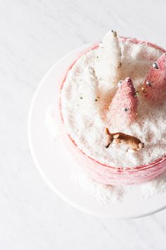 a white plate topped with a cake covered in powdered sugar