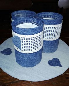 two blue and white baskets sitting on top of a wooden table