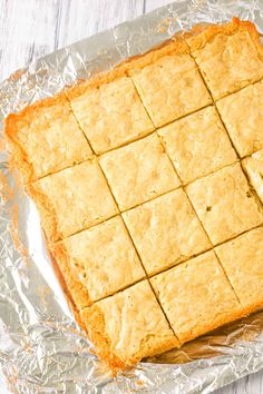 a square piece of cake sitting on top of tin foil