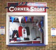 the corner store is filled with baseball jerseys and pennants hanging from the brick wall