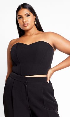 Seduce all evening long in the curve-loving stylings of our must-have Alexis Corset. Flaunting a crop hem and strapless bust, this gorgeous top ticks all the style boxes. Key Features Include: - Deep V neckline - Subtle structured boning - Stretch shirred back - Dropped front and crop back hemline - Fully lined - Back zip fastening - Crepe feel, slight stretch fabrication Wear with wide leg pants and strappy stilettos for an elevated party look. | Plus Size Corset Alexis 24 in Black, Size 18/M | City Chic Fitted Cropped Tube Top For Date Night, Cloth Styles, Corset Plus Size, Plus Size Clothing Online, Look Plus Size, Plus Size Corset, Half Shirts, Strappy Stilettos, Party Look