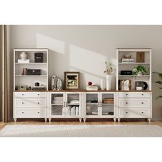 a living room filled with furniture and a large white bookcase on top of a wooden floor