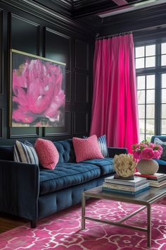 a living room with black walls and pink curtains on the window sill, blue couches