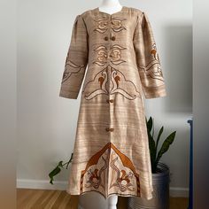 Vintage Handmade Raw Silk Embroidered/Appliqu Ethnic Caftan. Beautiful Champagne Colored Background With In Color With Orange, Brown, & Beige Embroidery/Applique Throughout The Front & On The Puff Sleeves. It Closes With Hook & Eye Closures At The Front With Faux Buttons Details. The Dress Is In Great Vintage Condition With No Noted Flaws Such As Stains Or Holes. No Size Tag, But Would Best Fit A Modern Large, Extra Large Or 2xl (Depending On The Fit You Want). Measurements: Shoulder To Shoulder-16” Bust/Armpit To Armpit-20” Waist-19” Length/Shoulder To Bottom-44” Hips-25.5” Sleeves-20” ***All Measurements Taken With Item Laying Flat & Should Be Doubled Where Needed*** Pleas Festive Long Sleeve Kaftan With Woven Motifs, Festive Beige Kaftan With Resham Embroidery, Spring Beige Embroidered Kurta, Fitted Long Sleeve Kaftan With Floral Embroidery, Bohemian Beige Kurta For Eid, Beige Long Sleeve Kaftan For Eid, Bohemian Beige Kurta With Chikankari Embroidery, Festive Embroidered Beige Kaftan, Festive Beige Bohemian Kurta