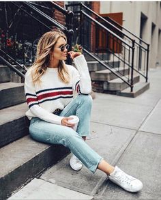 a woman sitting on the steps talking on her cell phone