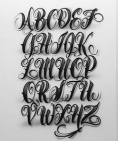 some type of lettering that looks like it is made out of black and white paper