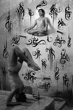 a man doing yoga poses in front of an artistic wall with letters and symbols on it