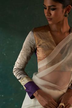 From festive to wedding, our gota sari that makes you stand out from the rest, paired with a multi tissue patchwork long sleeve blouse that adds a touch of glamour. This contemporary sari has the feel of the old world charm that is perfectly blending with the modern style. Gold tissue blazer over it not only gives a fusion contemporary touch but also keeps you warm yet glam. White Cotton Silk Festive Sets, Festive White Cotton Silk Set, Fitted Cotton Silk Saree With Sheer Dupatta, Festive Blouse With Sheer Dupatta For Eid, Festive Pre-draped Chanderi Saree, Fitted Gota Work Pre-draped Saree In Chanderi, Fitted Chanderi Saree With Gota Work, Fitted Chanderi Pre-draped Saree With Gota Work, Fitted Pre-draped Gota Work Saree In Chanderi