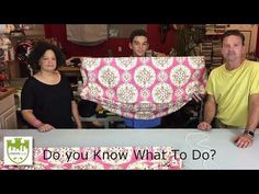 three people standing behind a table covered in pink and white fabric with the words do you know what to do?