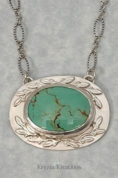 Nature-Inspired Turquoise Pendant Necklace in Sterling Silver with Leaves Nature-inspired Turquoise Jewelry With Large Stone, Oval Cabochon Necklace With Nature-inspired Style, Oval Turquoise Necklace With Large Pendant, Turquoise Necklace With Large Oval Stone Pendant, Turquoise Necklace With Large Oval Pendant, Turquoise Necklace With Large Oval Stone, Oval Turquoise Necklace With Natural Stones, Green Oval Cabochon Turquoise Necklace, Sterling Silver Oval Necklace With Nature-inspired Style